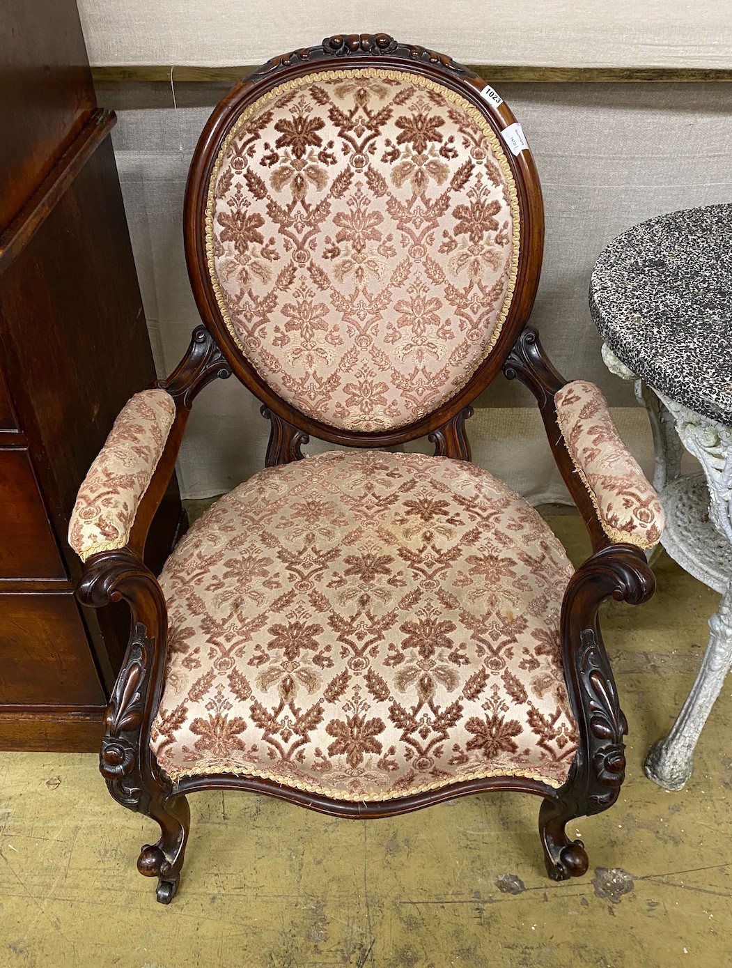 A Victorian carved walnut spoon back open armchair, width 71cm, depth 60cm, height 95cm